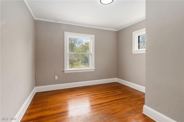 3338 E 130th St, Cleveland, OH 44120 - unfurnished room with ornamental molding, healthy amount of natural light, hardwood / wood-style floors, and baseboards