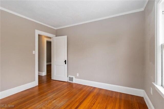 3338 E 130th St, Cleveland, OH 44120 - unfurnished room with wood finished floors, baseboards, and ornamental molding