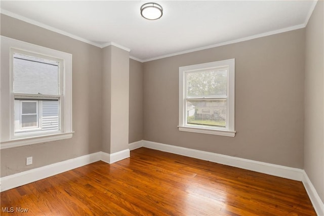 3338 E 130th St, Cleveland, OH 44120 - empty room with baseboards, wood finished floors, and crown molding