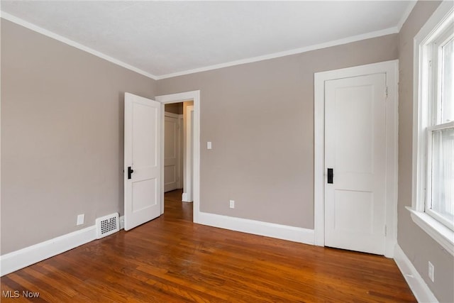 3338 E 130th St, Cleveland, OH 44120 - unfurnished bedroom featuring wood finished floors, baseboards, and crown molding