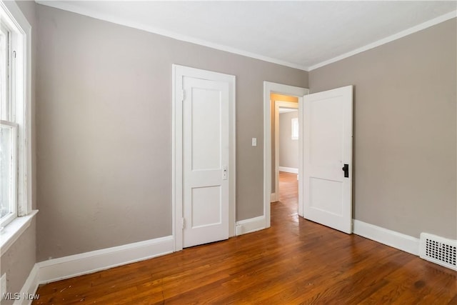 3338 E 130th St, Cleveland, OH 44120 - unfurnished bedroom with wood finished floors, ornamental molding, and baseboards