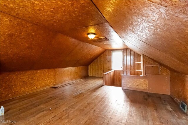 3338 E 130th St, Cleveland, OH 44120 - bonus room featuring hardwood / wood-style floors, vaulted ceiling, and wood walls