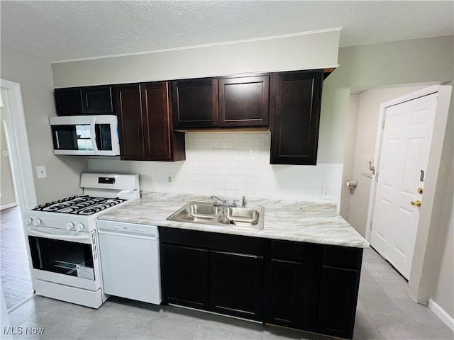 4780 E 173rd St, Cleveland, OH 44128 - kitchen with white appliances, a sink, decorative backsplash, a textured ceiling, and dark brown cabinetry
