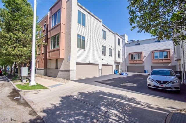 1425 Lindazzo Ave, Cleveland, OH 44114 - view of building exterior with an attached garage and driveway