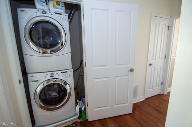 1425 Lindazzo Ave, Cleveland, OH 44114 - laundry room featuring stacked washer / drying machine, dark wood-style flooring, and baseboards