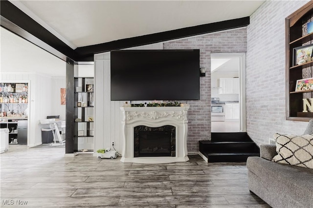 3804 Collins Way, Weirton, WV 26062 - living room featuring wood finished floors, a fireplace, and brick wall