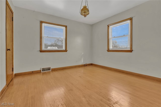 340 53rd St SW, Canton, OH 44706 - spare room with light wood-type flooring, healthy amount of natural light, and baseboards