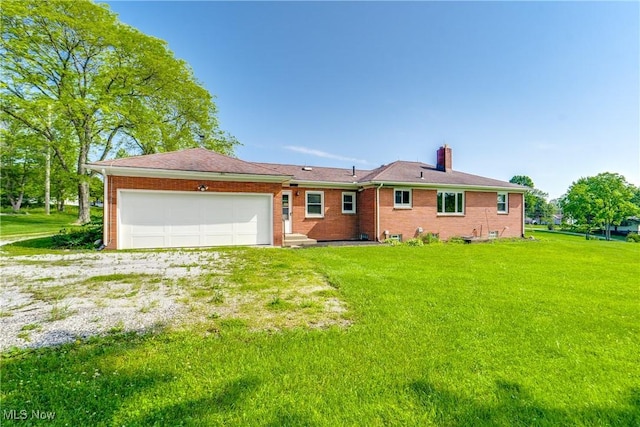 340 53rd St SW, Canton, OH 44706 - view of front of property with a chimney, an attached garage, a front yard, and brick siding