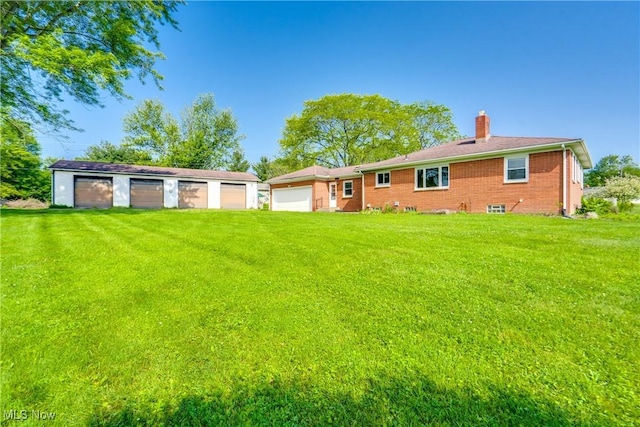 340 53rd St SW, Canton, OH 44706 - back of house with a chimney, a lawn, and brick siding