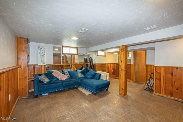 21202 Franklin Rd, Maple Heights, OH 44137 - living room featuring wainscoting, wooden walls, and a textured ceiling