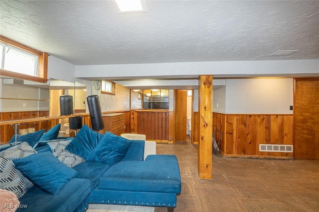 21202 Franklin Rd, Maple Heights, OH 44137 - living room with wood walls, wainscoting, and a textured ceiling