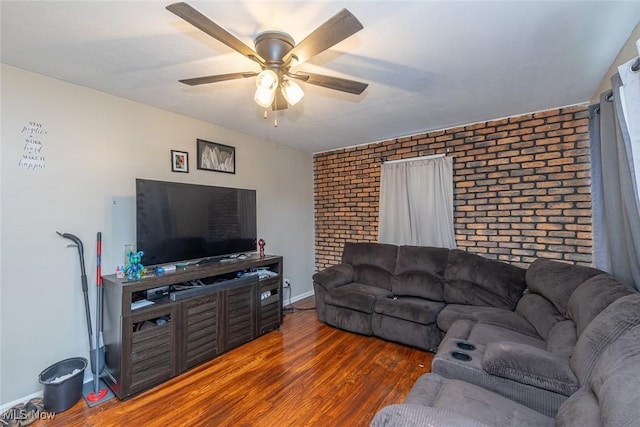 21202 Franklin Rd, Maple Heights, OH 44137 - living room featuring brick wall, wood finished floors, a ceiling fan, and baseboards