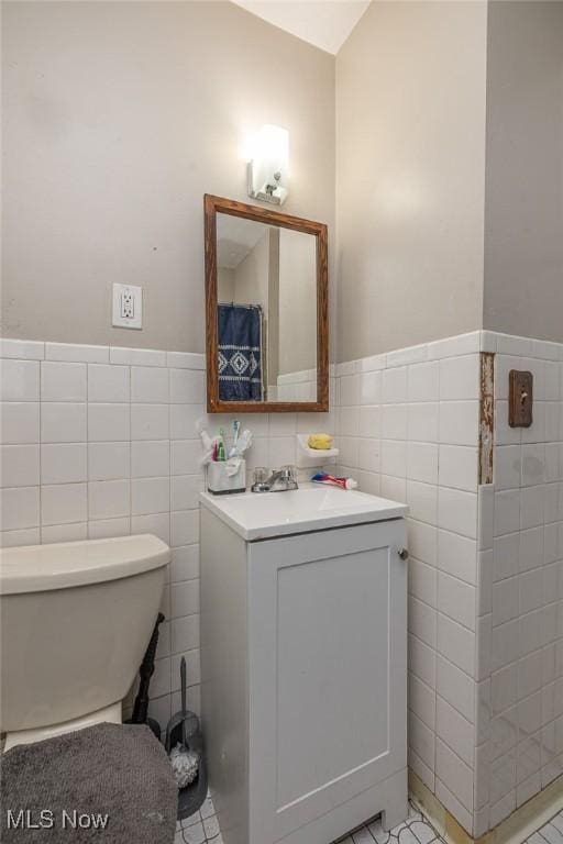 21202 Franklin Rd, Maple Heights, OH 44137 - bathroom with tile walls, toilet, vanity, and wainscoting