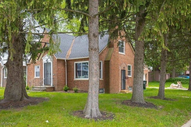 1547 Genesee Rd, South Euclid, OH 44121 - view of front facade featuring brick siding, a front lawn, and a shingled roof