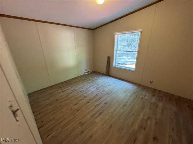 48901 State Route 154, Rogers, OH 44455 - unfurnished room with vaulted ceiling, wood finished floors, and crown molding