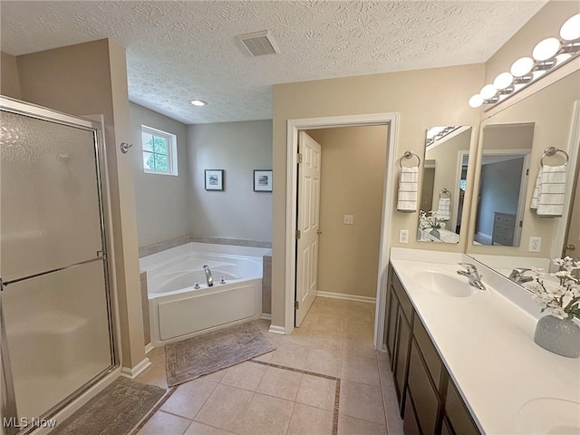 15532 Raya Oval, North Royalton, OH 44133 - bathroom featuring a bath, a shower stall, double vanity, tile patterned floors, and baseboards