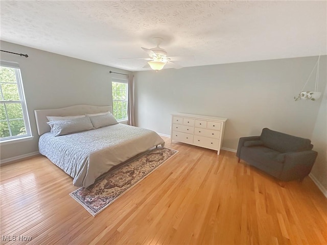 15532 Raya Oval, North Royalton, OH 44133 - bedroom featuring wood finished floors, baseboards, a textured ceiling, and ceiling fan