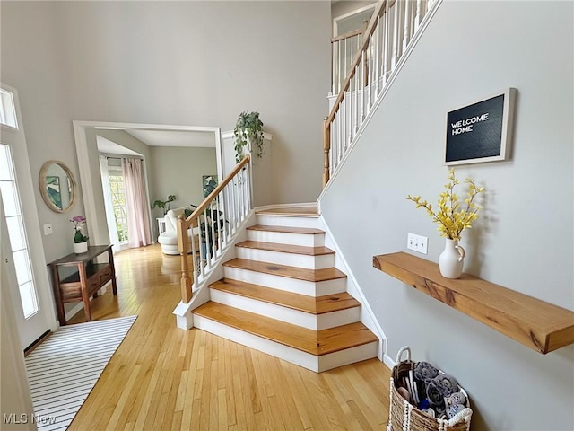 15532 Raya Oval, North Royalton, OH 44133 - stairs with a towering ceiling, wood-type flooring, and baseboards