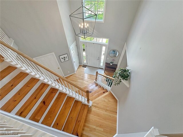 15532 Raya Oval, North Royalton, OH 44133 - foyer featuring a towering ceiling, healthy amount of natural light, stairs, a chandelier, and baseboards