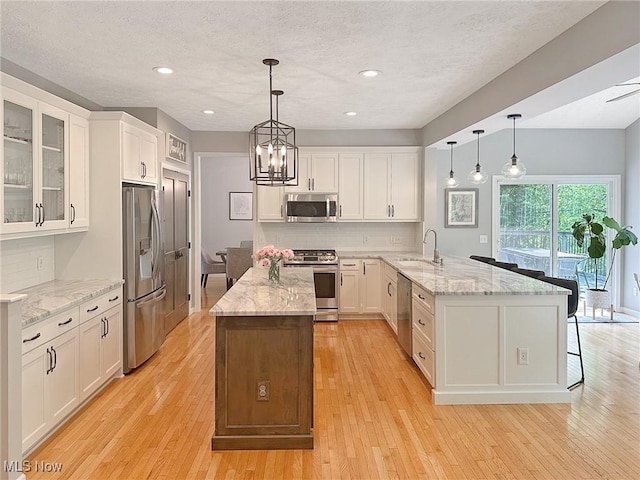 15532 Raya Oval, North Royalton, OH 44133 - kitchen featuring stainless steel appliances, a peninsula, a sink, tasteful backsplash, and recessed lighting