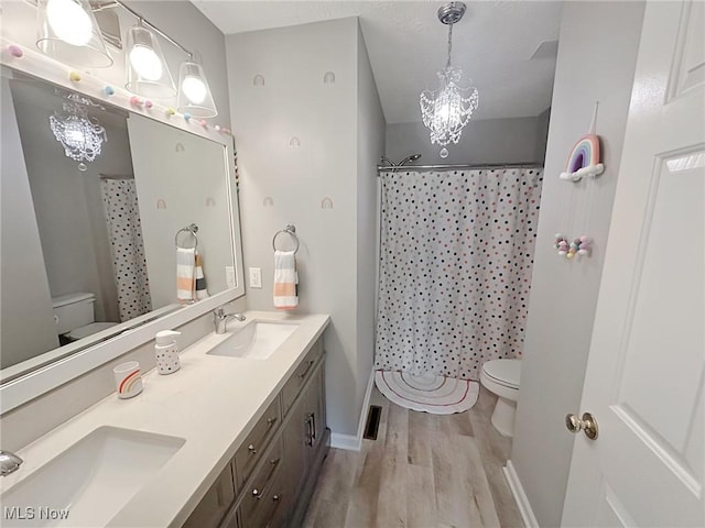 15532 Raya Oval, North Royalton, OH 44133 - bathroom with toilet, wood finished floors, double vanity, and baseboards