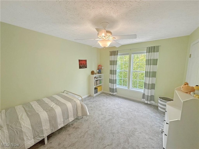 15532 Raya Oval, North Royalton, OH 44133 - bedroom with baseboards, carpet, a textured ceiling, and a ceiling fan