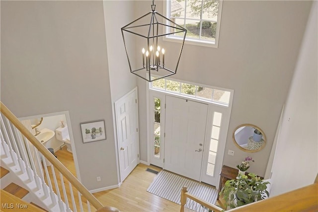 15532 Raya Oval, North Royalton, OH 44133 - entrance foyer featuring a towering ceiling, wood finished floors, stairs, a chandelier, and baseboards
