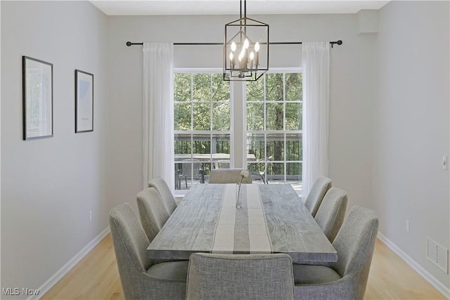 15532 Raya Oval, North Royalton, OH 44133 - dining area featuring a chandelier, light wood-type flooring, and baseboards