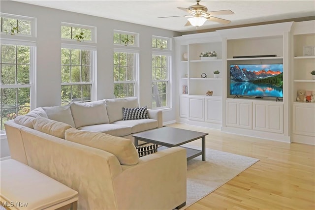 15532 Raya Oval, North Royalton, OH 44133 - living area featuring plenty of natural light, light wood-type flooring, a ceiling fan, and built in shelves