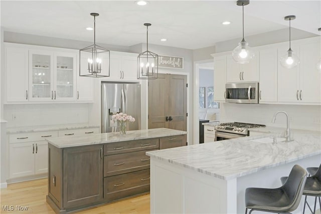 15532 Raya Oval, North Royalton, OH 44133 - kitchen featuring stainless steel appliances, a sink, glass insert cabinets, white cabinetry, and recessed lighting