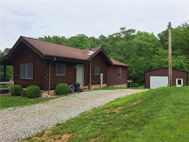 62158 Savage Rd, Cambridge, OH 43725 - view of front facade with a detached garage, an outdoor structure, driveway, and a front lawn