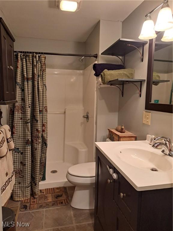 62158 Savage Rd, Cambridge, OH 43725 - bathroom with toilet, vanity, curtained shower, and tile patterned floors