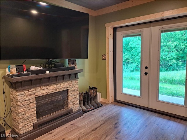62158 Savage Rd, Cambridge, OH 43725 - doorway to outside featuring wood finished floors, baseboards, french doors, and a stone fireplace