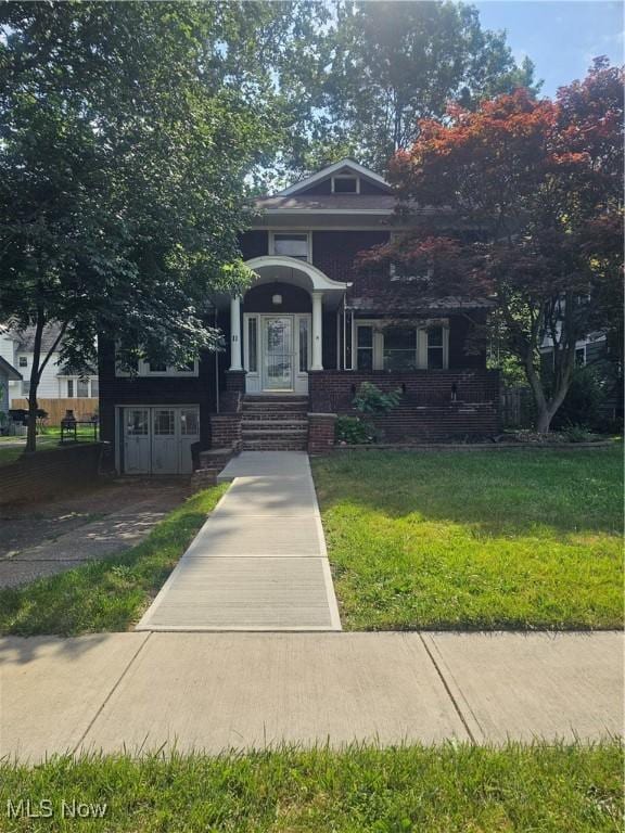 11 Adams St, Berea, OH 44017 - view of front facade with a front lawn and brick siding