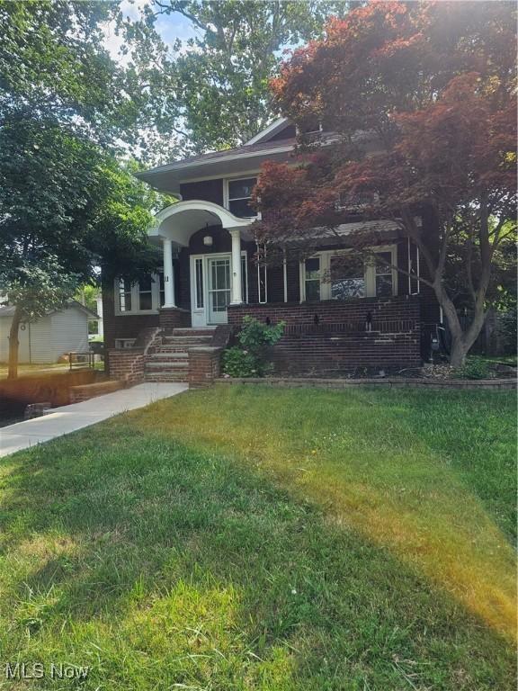 11 Adams St, Berea, OH 44017 - view of front of house featuring a front yard, a porch, and brick siding