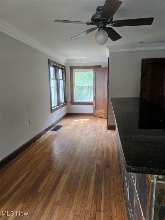 11 Adams St, Berea, OH 44017 - unfurnished living room with hardwood / wood-style flooring, ornamental molding, and a ceiling fan