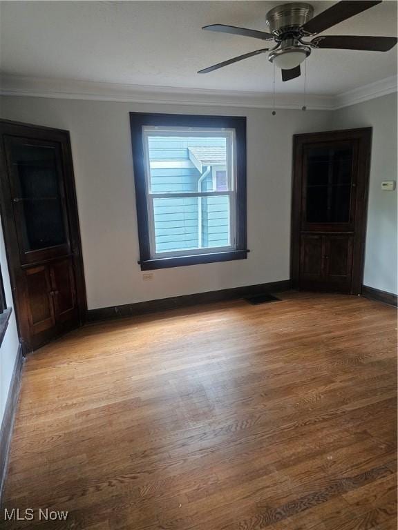 11 Adams St, Berea, OH 44017 - unfurnished room featuring light wood-style flooring, crown molding, and ceiling fan