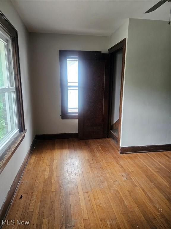 11 Adams St, Berea, OH 44017 - unfurnished room with wood-type flooring, plenty of natural light, and a ceiling fan