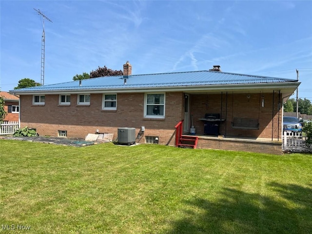 812 Ike St, Minerva, OH 44657 - back of house with a chimney, a yard, and brick siding