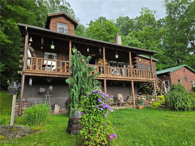 424 Avalon Rd SW, Dellroy, OH 44620 - back of house with stairway, log siding, a yard, a deck, and a chimney