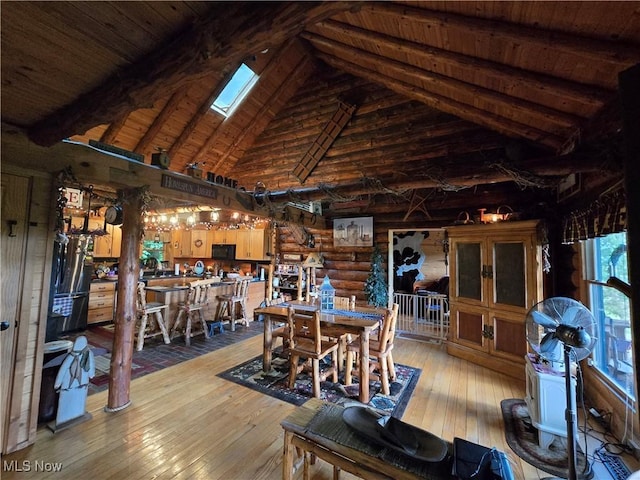424 Avalon Rd SW, Dellroy, OH 44620 - dining room with rustic walls, wood ceiling with exposed beams, high vaulted ceiling, and hardwood / wood-style floors