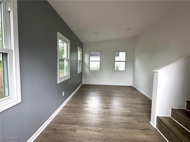 4570 N Leavitt Rd NW, Warren, OH 44485 - spare room with vaulted ceiling, healthy amount of natural light, stairway, and dark wood-style flooring