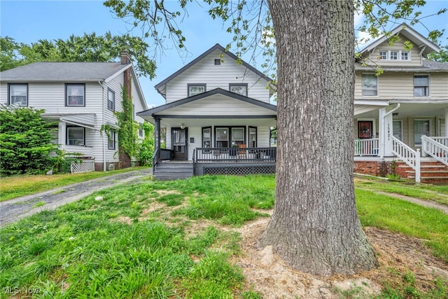 15417 Parkgrove Ave, Cleveland, OH 44110 - view of front of home with a porch and a front lawn
