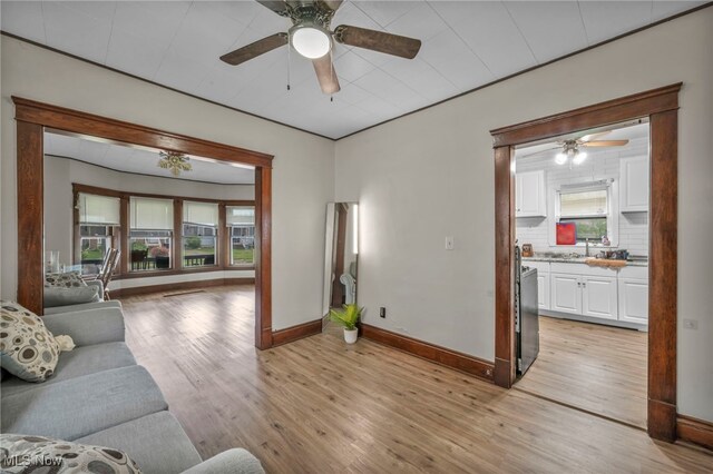 15417 Parkgrove Ave, Cleveland, OH 44110 - living room featuring ceiling fan, light wood-style flooring, and plenty of natural light
