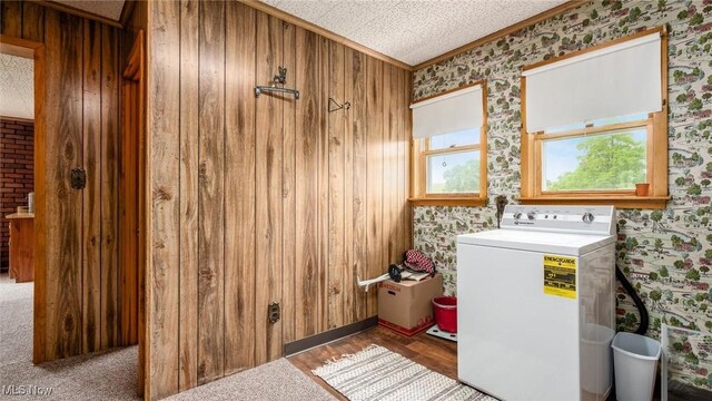 73117 Deck Rd, Freeport, OH 43973 - laundry area with washer / dryer, wallpapered walls, crown molding, and wood finished floors
