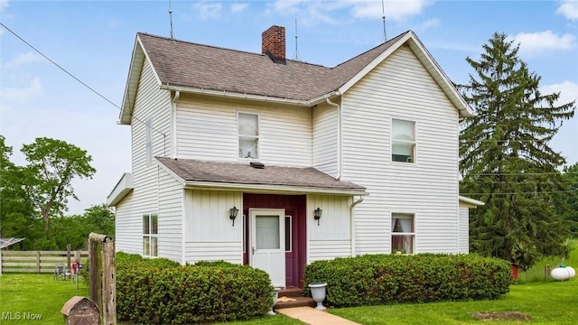 73117 Deck Rd, Freeport, OH 43973 - traditional-style home with a chimney, roof with shingles, and board and batten siding