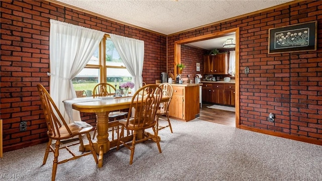 73117 Deck Rd, Freeport, OH 43973 - dining room with brick wall, light carpet, and ornamental molding