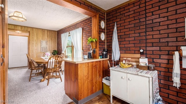 73117 Deck Rd, Freeport, OH 43973 - bar featuring brick wall, ornamental molding, wooden walls, and a textured ceiling