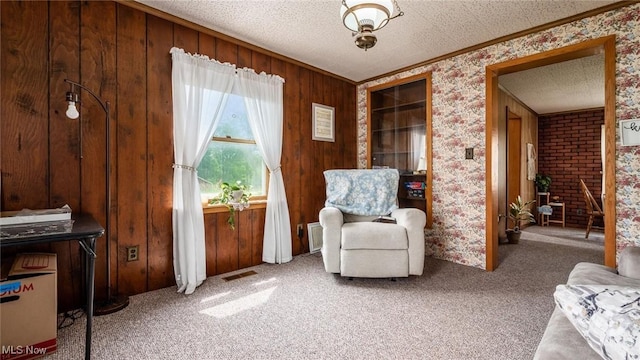 73117 Deck Rd, Freeport, OH 43973 - living area with ornamental molding, light colored carpet, a textured ceiling, and wooden walls