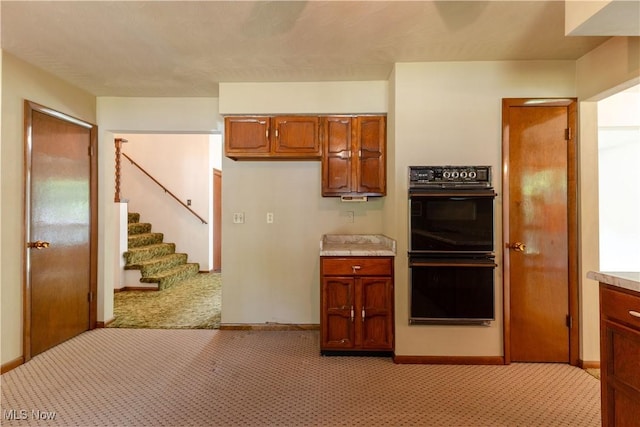 41510 Alderlick Rd, Wellsville, OH 43968 - kitchen featuring brown cabinets, light colored carpet, and light countertops